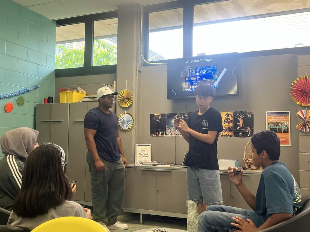 Mentor and student presenting an Arduino lesson to the group