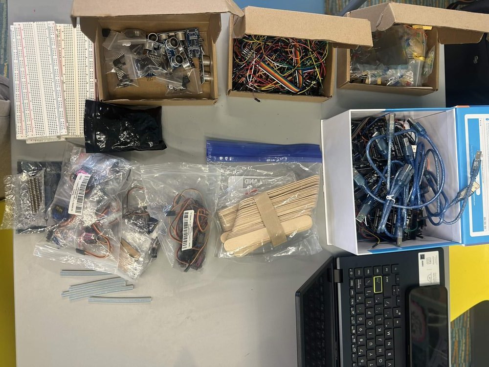 Bins of donated electronics components including breadboards, servos, and wires