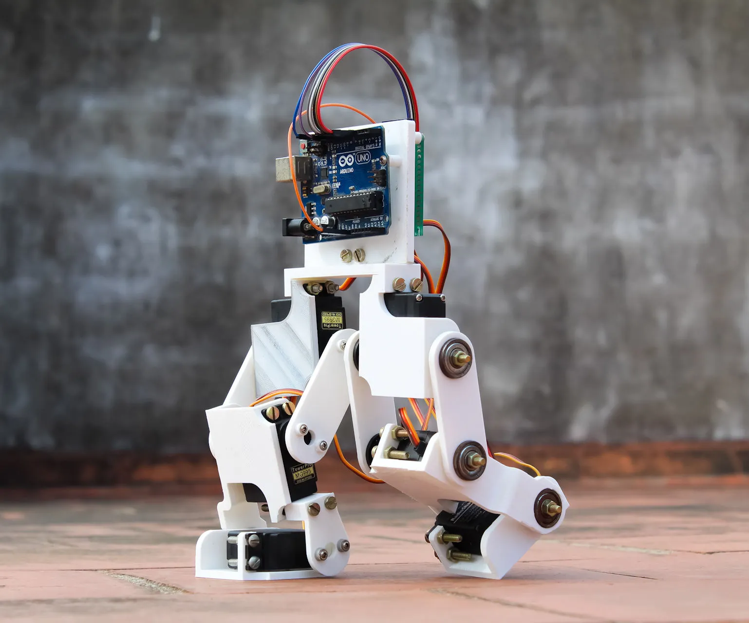 Two-legged walking robot with an Arduino mounted on top
