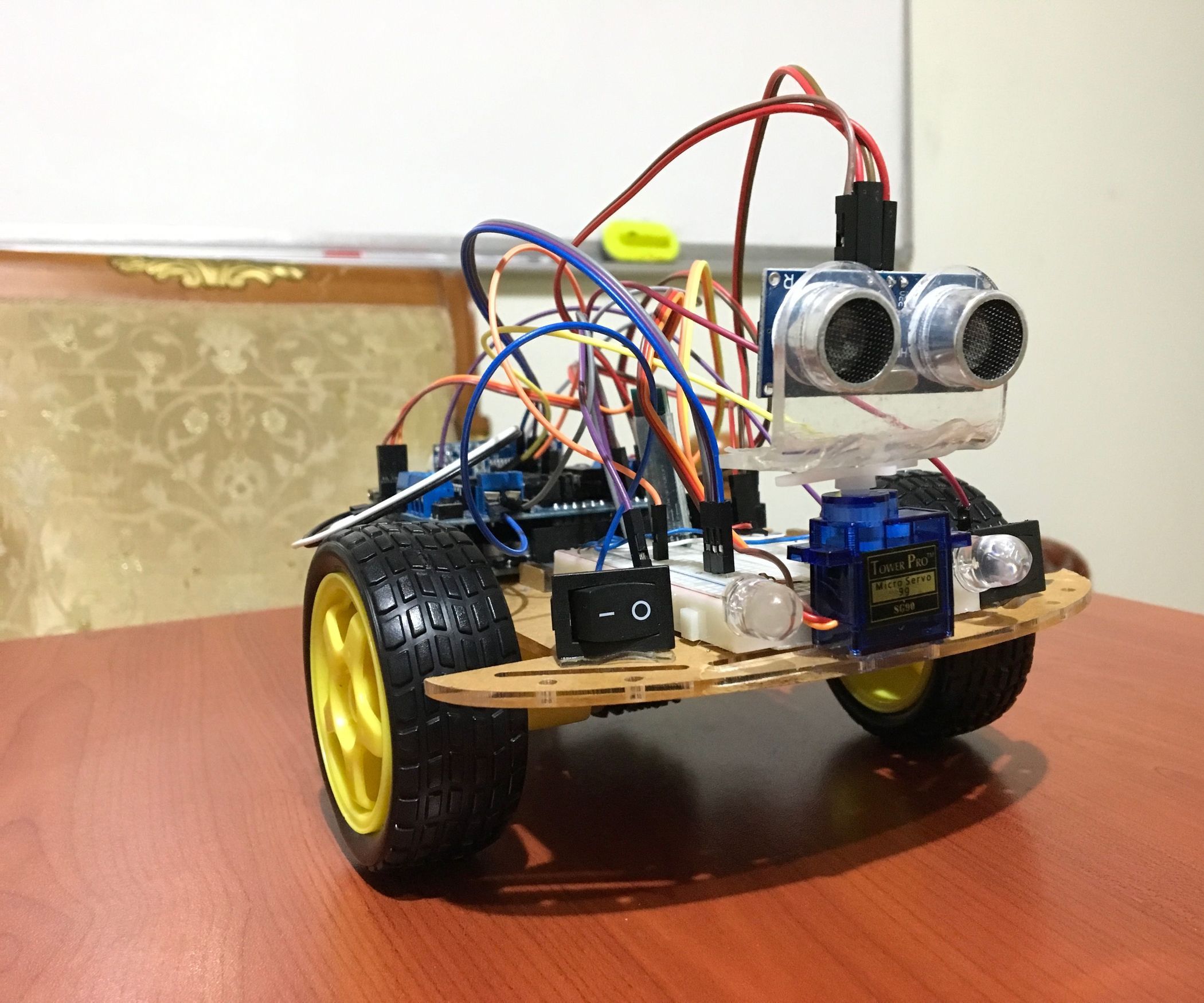 Robotics car with an ultrasonic distance sensor mounted on a servo